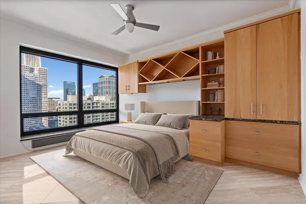 a bedroom with a bed and a large window