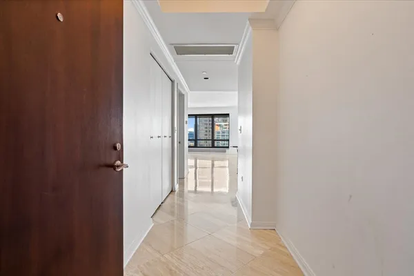a view of a hallway with a dining room