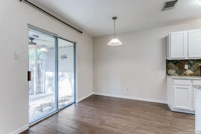 a kitchen with granite countertop a sink a counter top space stainless steel appliances and cabinets