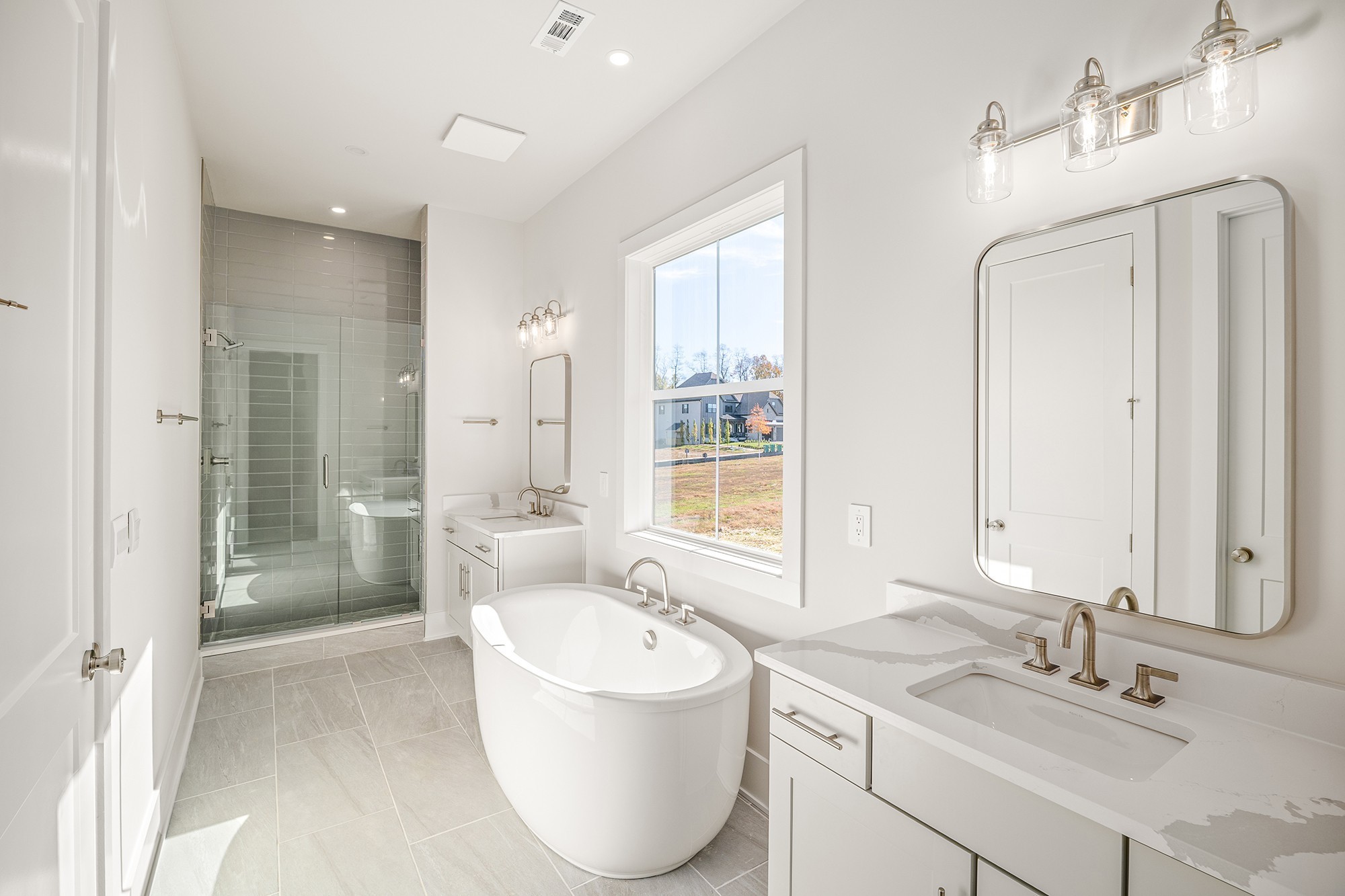 1420 Round Hill Lane Spring Hill, TN 37174 - Photo 17 of 29 a spacious bathroom with a bathtub shower sink and mirror