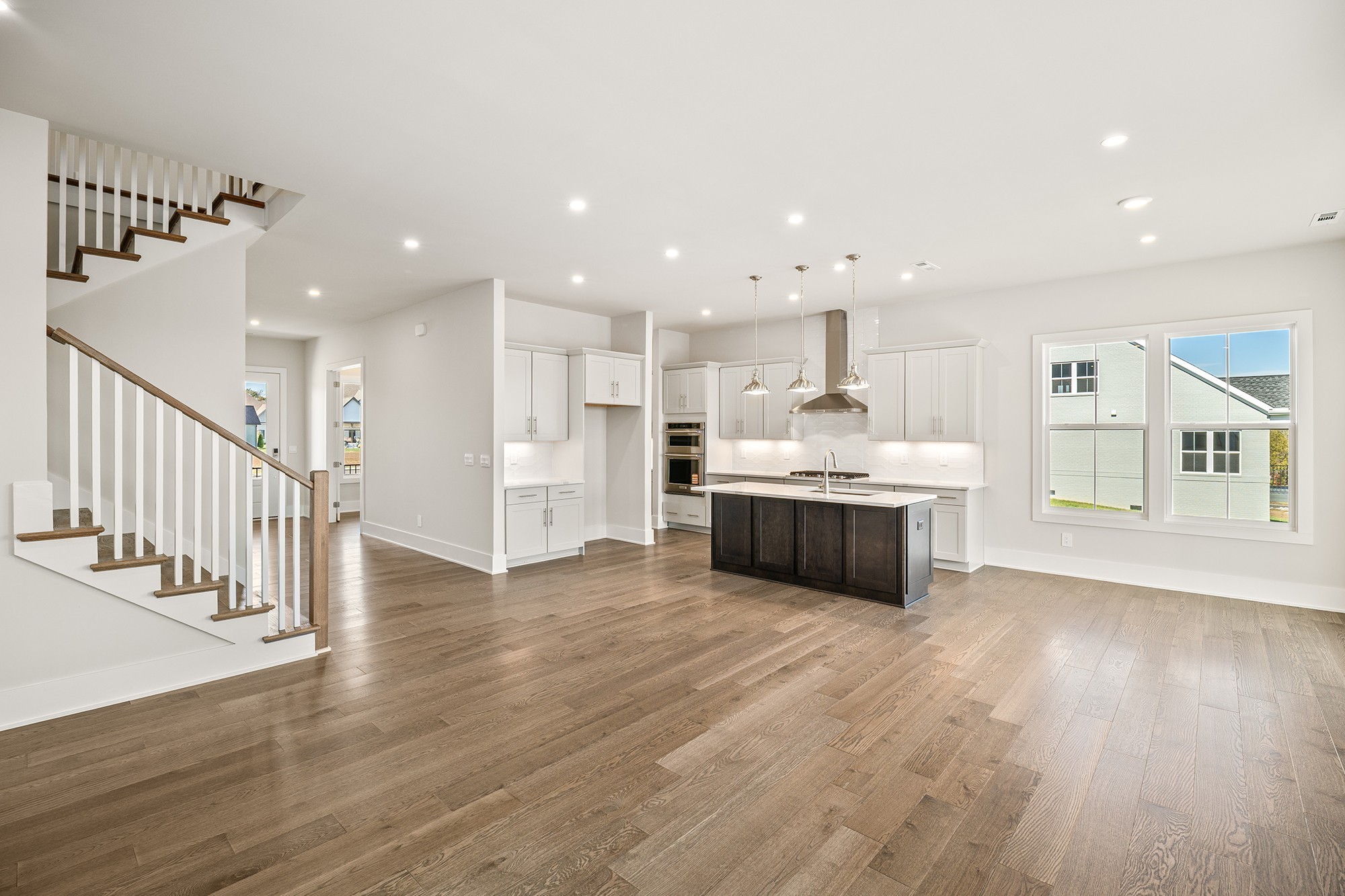 1420 Round Hill Lane Spring Hill, TN 37174 - Photo 6 of 29 a large kitchen with a center island wooden floor and stainless steel appliances