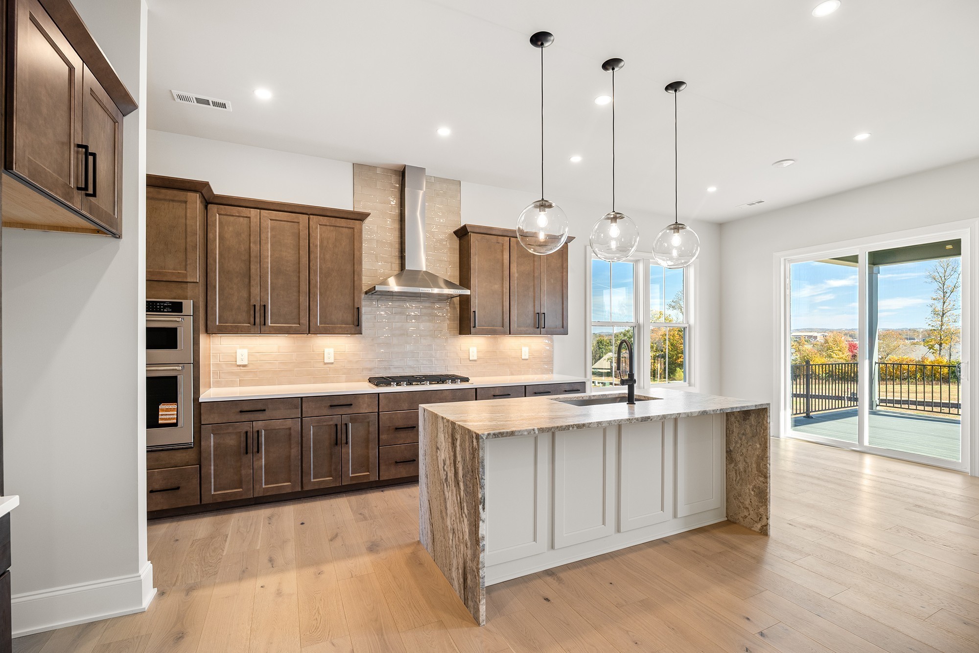 1420 Round Hill Lane Spring Hill, TN 37174 - Photo 10 of 29 a kitchen with stainless steel appliances granite countertop a stove a sink and a refrigerator