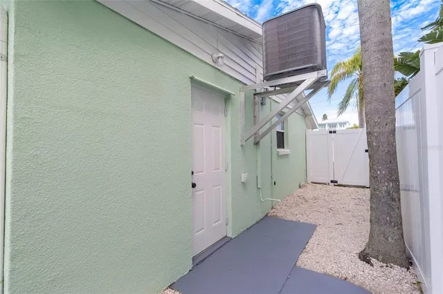 a view of a brick house with a small yard
