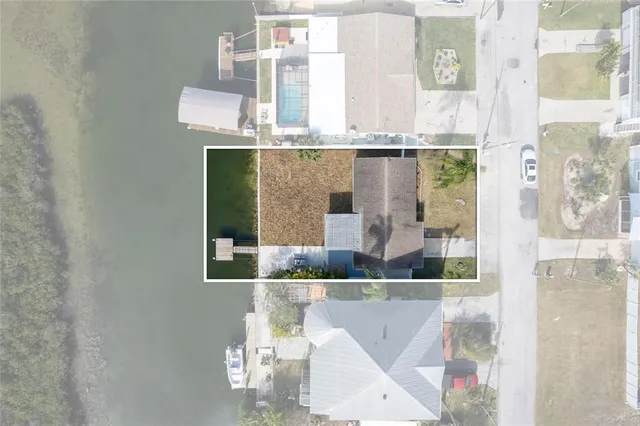 an aerial view of a house with a lake view