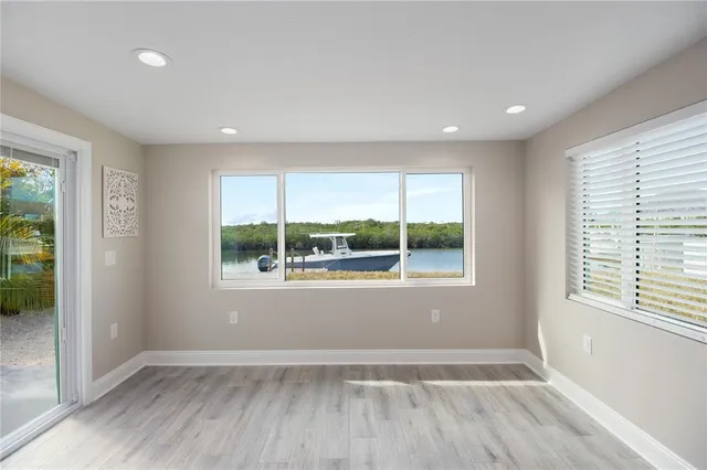 a view of a room with wooden floor and a window