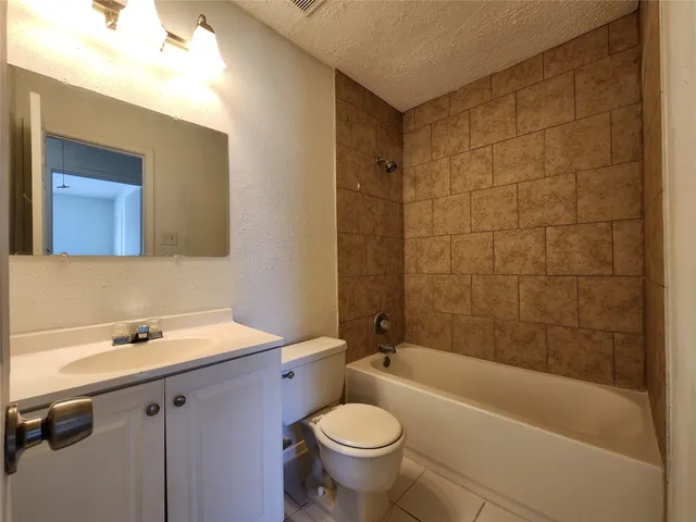 a bathroom with a sink mirror toilet and bathtub