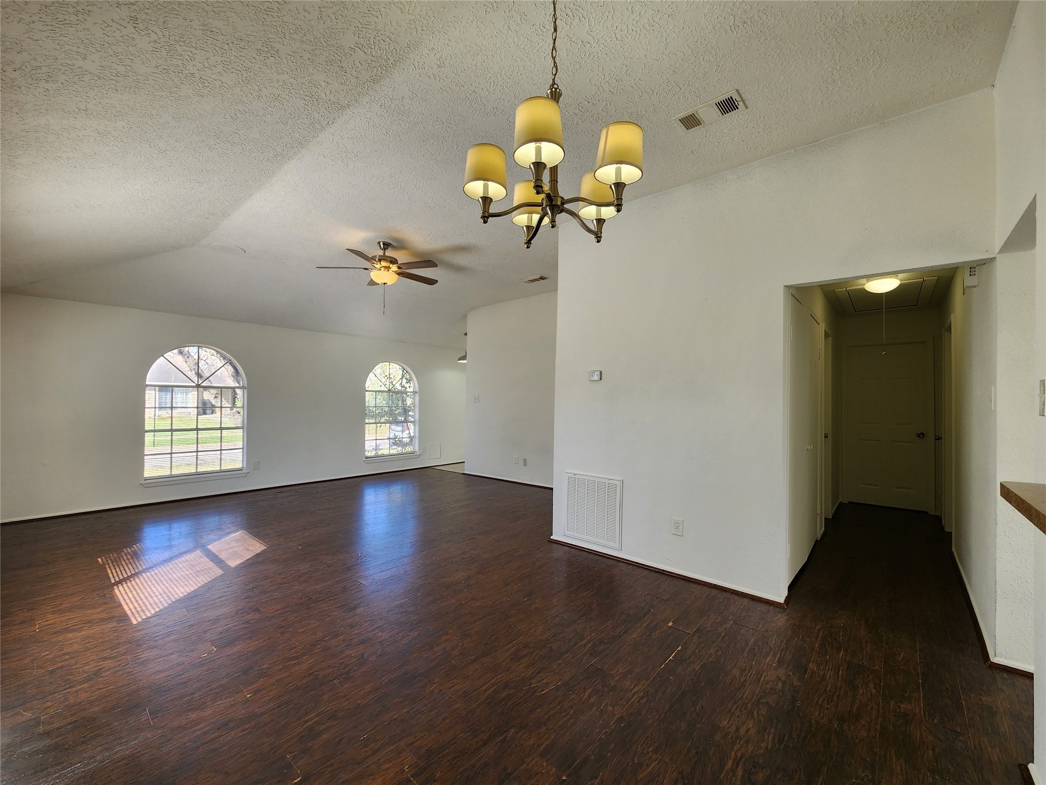 2446 Autumn Springs Lane Spring, TX 77373 - Photo 7 of 13 a view of a room with wooden floor and chandelier