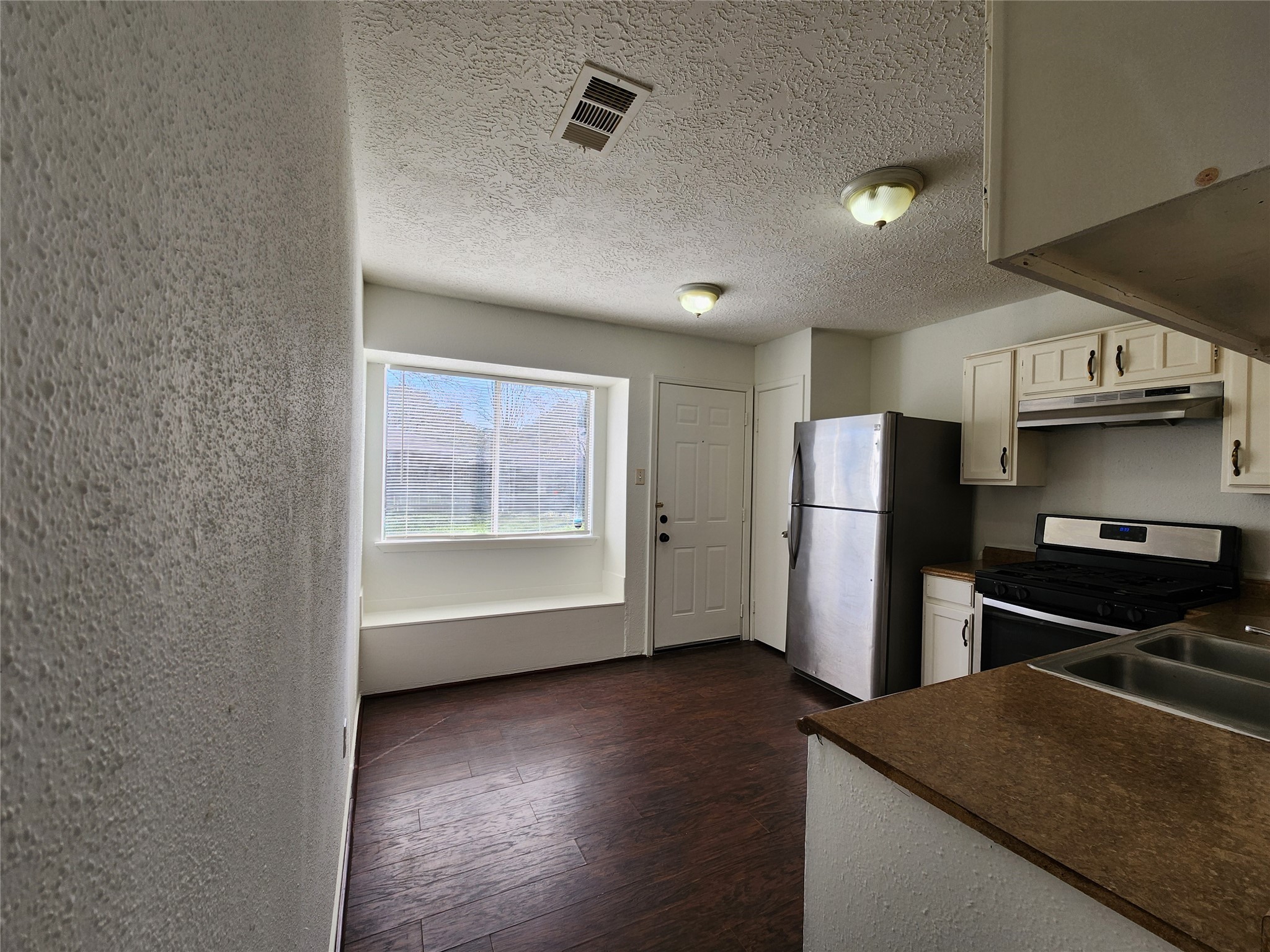 2446 Autumn Springs Lane Spring, TX 77373 - Photo 8 of 13 a view of a kitchen with a fridge and wooden floor