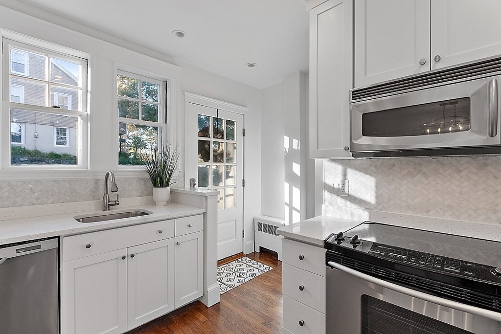 7 Gayland Road Needham, MA 02492 - Photo 10 of 16 a kitchen with stainless steel appliances white cabinets and a stove top oven