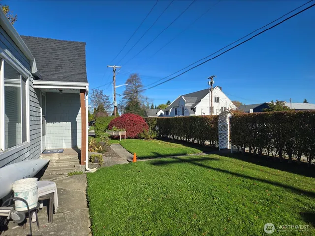 a view of a house with backyard sitting area and garden