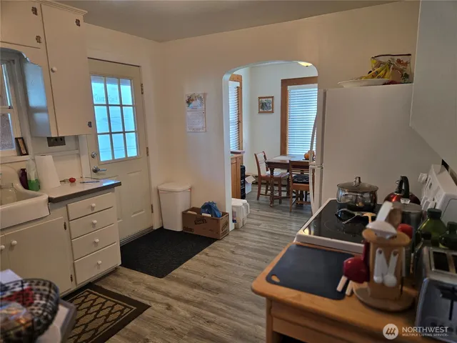 a view of workspace with wooden floor windows