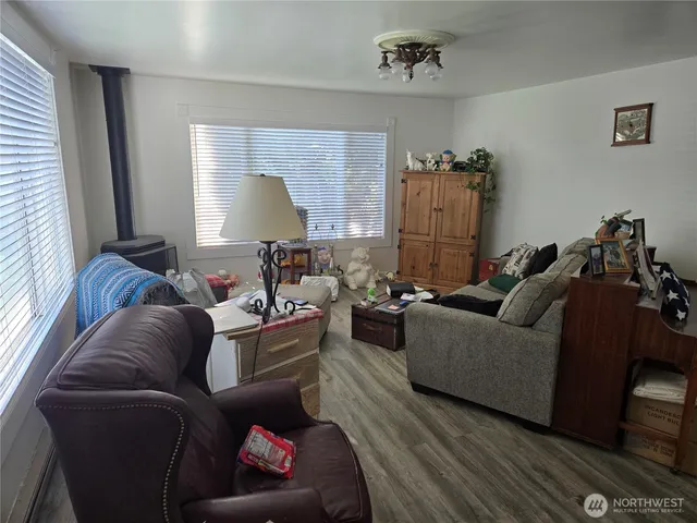 a kitchen with a sink and wooden floor