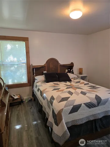 a bedroom with a bed and a dresser