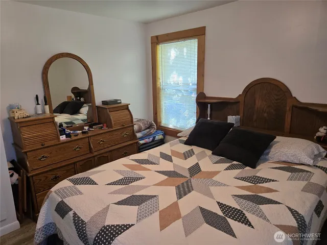 a bedroom with a bed and a dresser