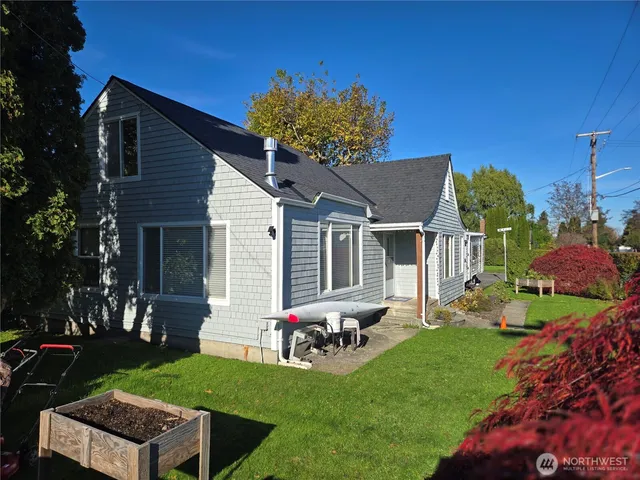 a backyard of a house with wooden floor barbeque oven and yard