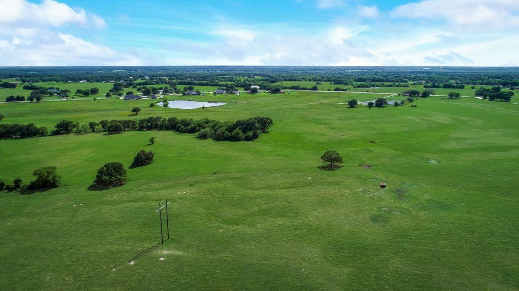 1 Co Road Kaufman, TX 75142 - Photo 5 of 7 a view of a lush green outdoor space with a swimming pool and valleys in the background