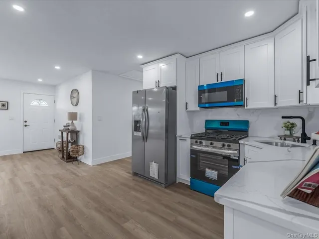 a kitchen with stainless steel appliances a refrigerator stove and sink