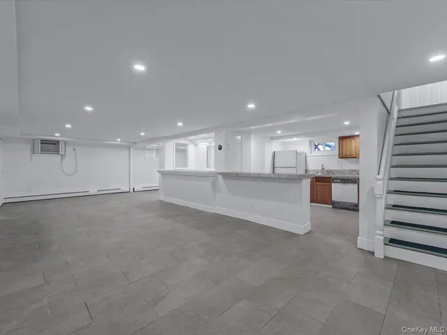 a view of an empty room with a kitchen