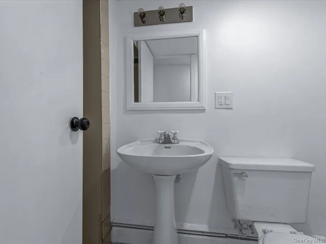 a bathroom with a sink a mirror and a toilet