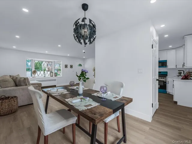 a view of a dining room with furniture wooden floor and chandelier