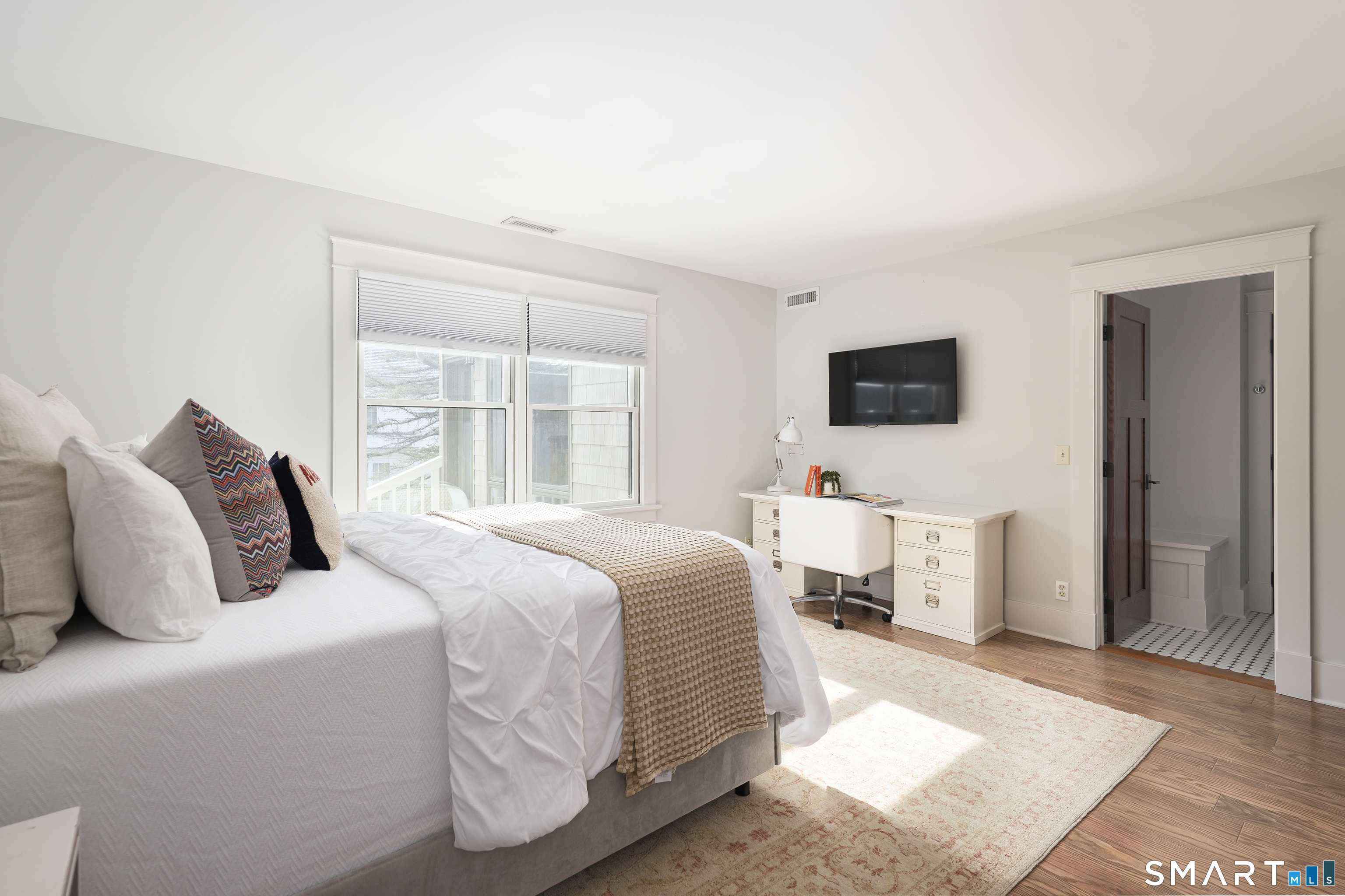 107 Parade Hill Road New Canaan, CT 06840 - Photo 15 of 28 a bedroom with a bed and wooden floor