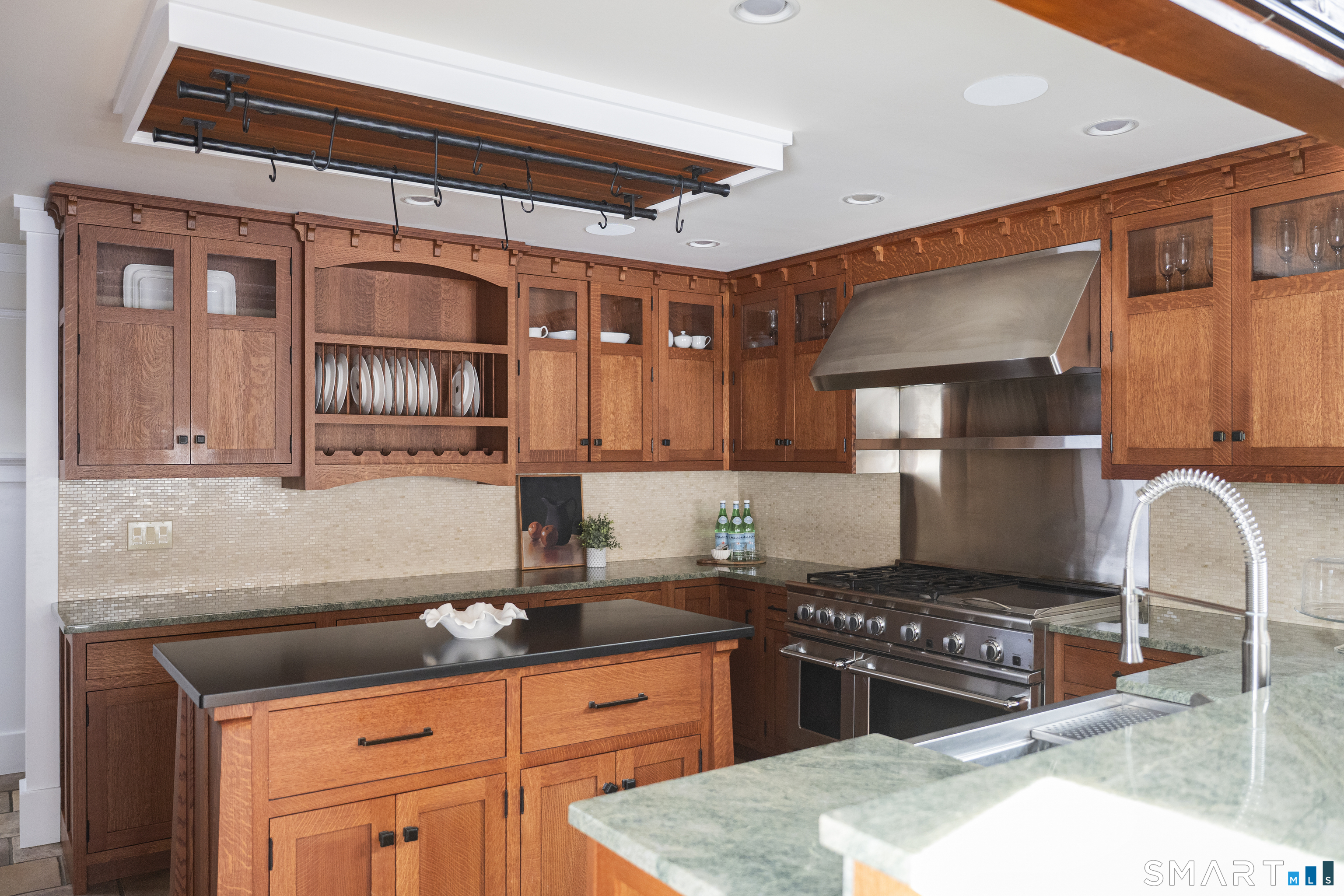 107 Parade Hill Road New Canaan, CT 06840 - Photo 8 of 28 a kitchen with stainless steel appliances granite countertop a stove top oven a sink dishwasher and cabinets with wooden floor