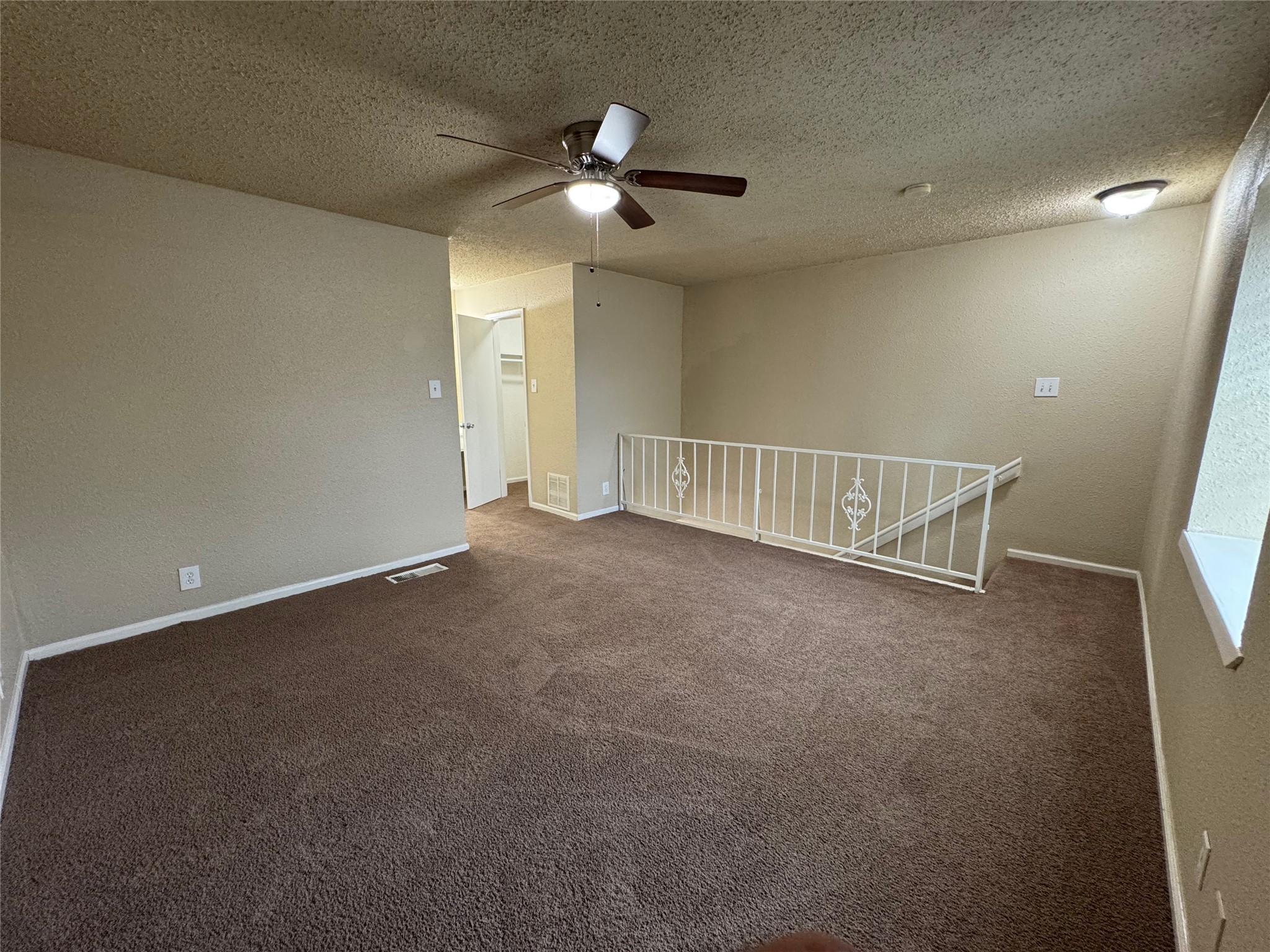 4904 West Wind Trail, Unit 101 Austin, TX 78745 - Photo 11 of 18 a view of an empty room with a chandelier fan