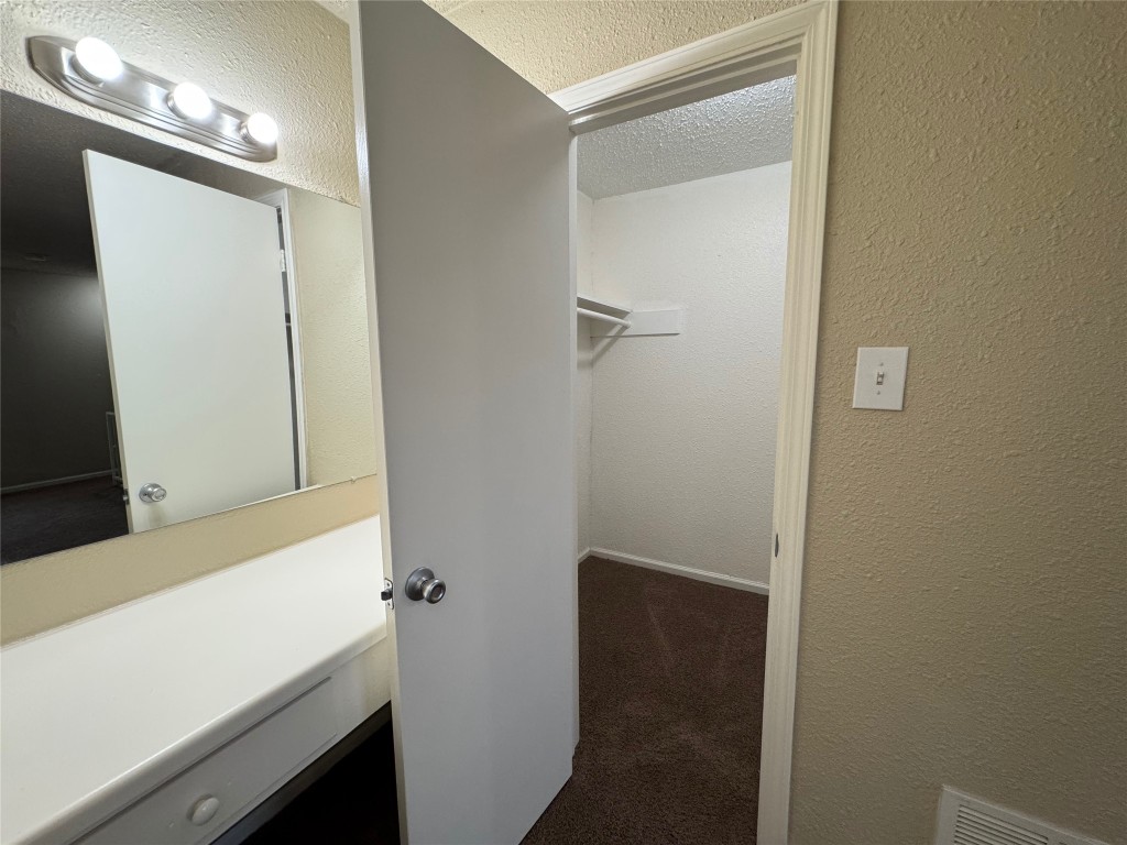4904 West Wind Trail, Unit 101 Austin, TX 78745 - Photo 13 of 18 a bathroom with a sink and a mirror
