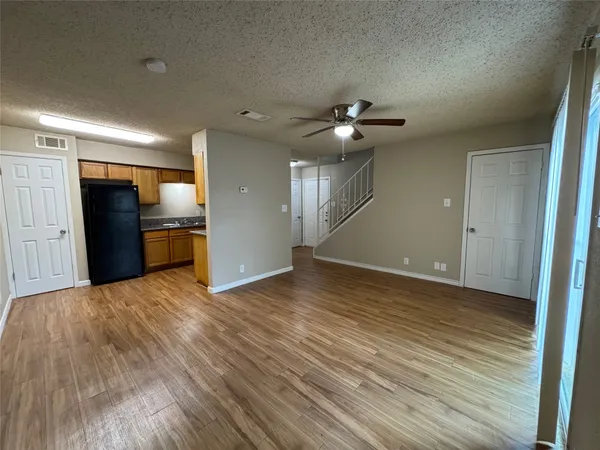 a view of a livingroom with a hardwood floor and a ceiling fan