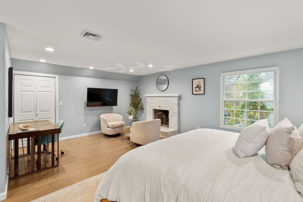 52 Condor Road Sharon, MA 02067 - Photo 16 of 36 a bedroom with a bed and a flat screen tv