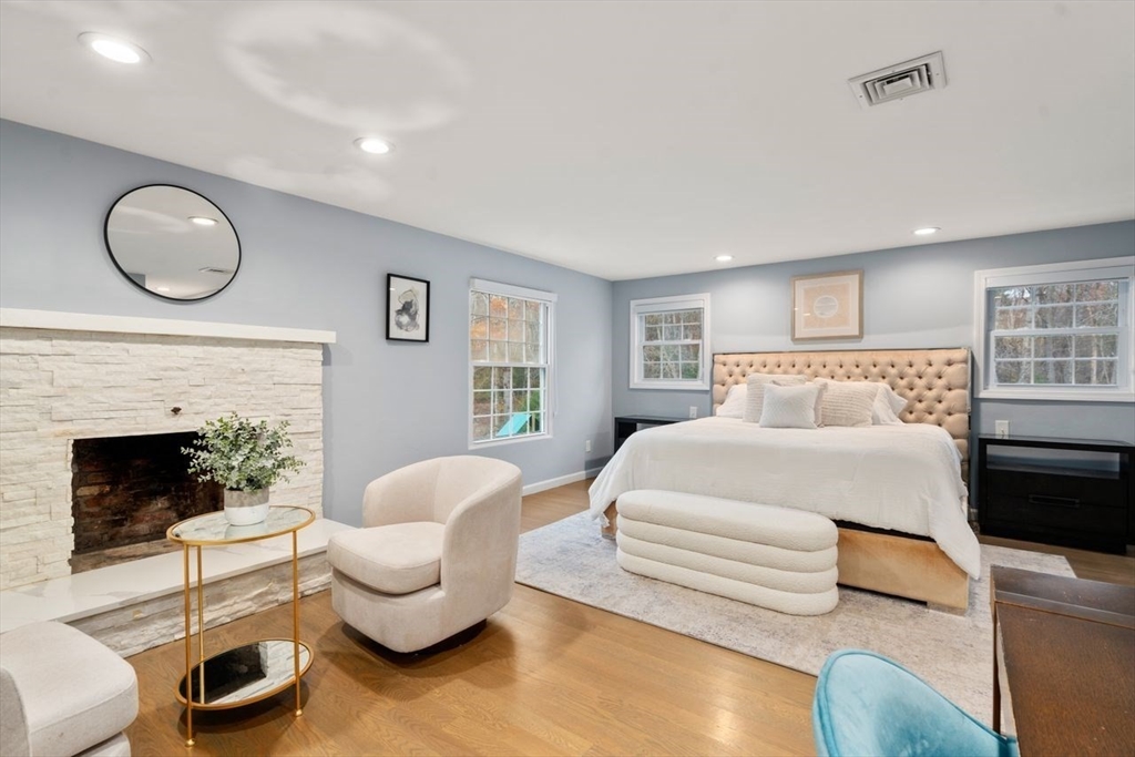 52 Condor Road Sharon, MA 02067 - Photo 17 of 36 a bedroom with a bed and a fireplace