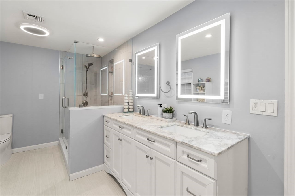 52 Condor Road Sharon, MA 02067 - Photo 18 of 36 a bathroom with a sink double vanity and a mirror