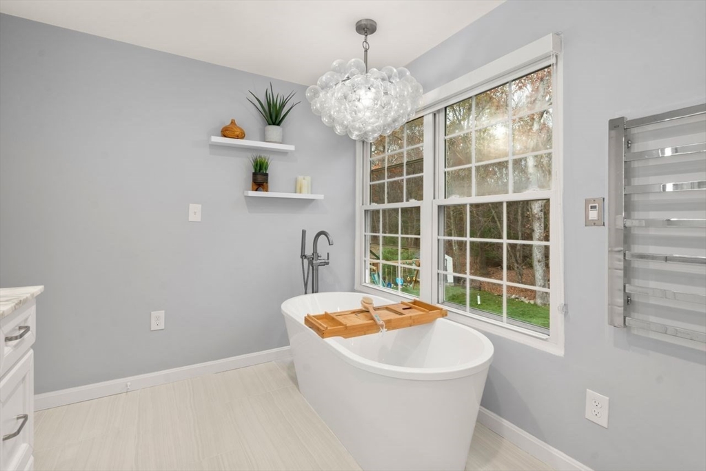 52 Condor Road Sharon, MA 02067 - Photo 19 of 36 a bathroom with a sink and a large mirror
