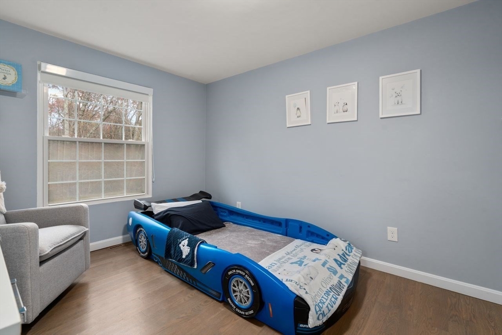 52 Condor Road Sharon, MA 02067 - Photo 23 of 36 a blue bed sitting in a bedroom next to a window