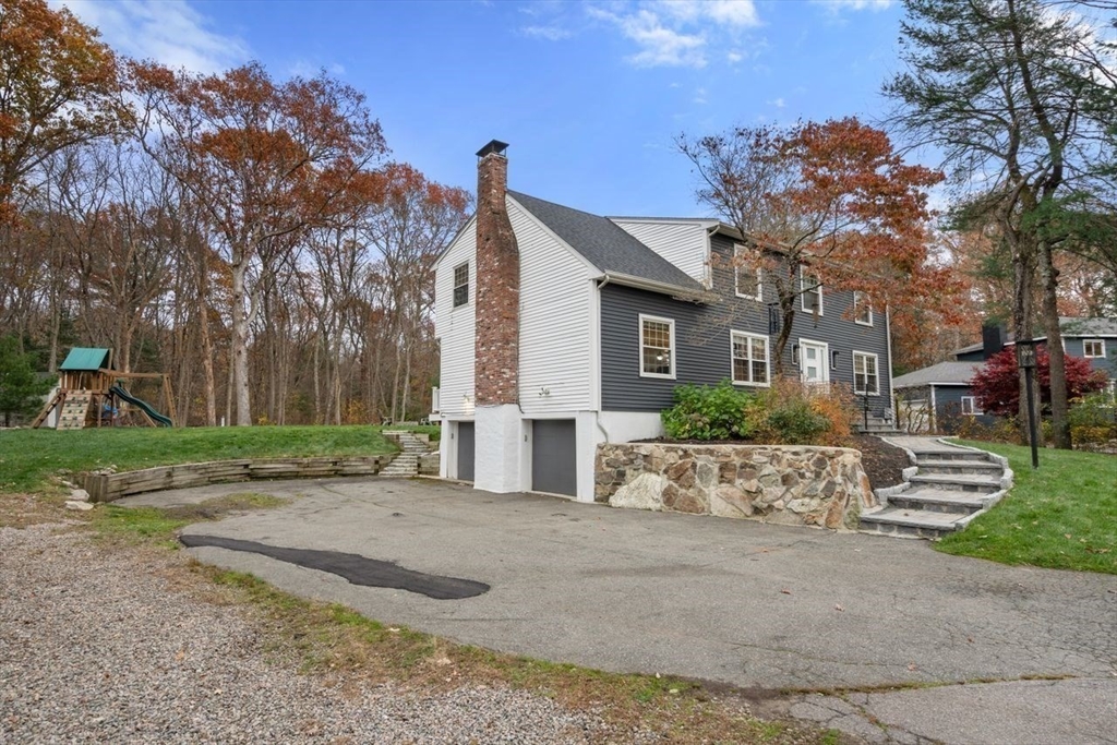 52 Condor Road Sharon, MA 02067 - Photo 32 of 36 a view of a house with a small yard and a large tree