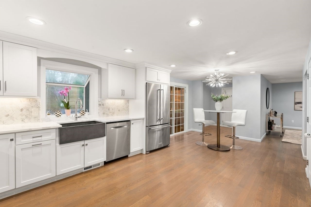 52 Condor Road Sharon, MA 02067 - Photo 4 of 36 a kitchen with a refrigerator and white cabinets