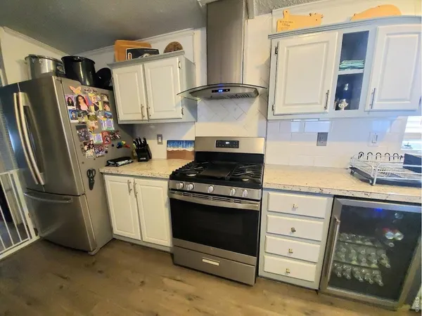 a kitchen with stainless steel appliances granite countertop a refrigerator stove and sink