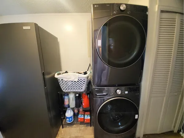 a close view of a utility room with dryer and washer