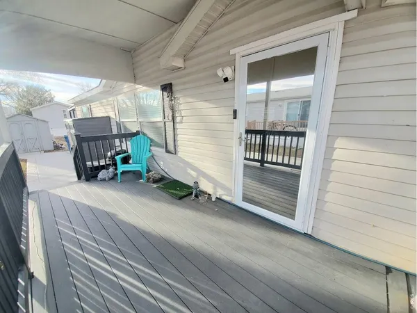 a view of a porch with a table and chairs