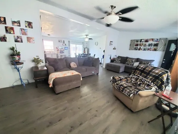 a living room with furniture and a ceiling fan