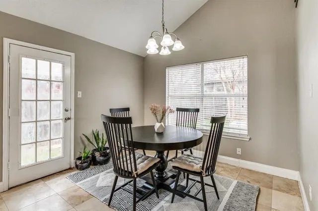 a dining room with furniture a chandelier and wooden floor