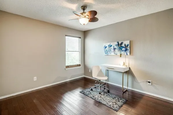 a living room with a table and a potted plant
