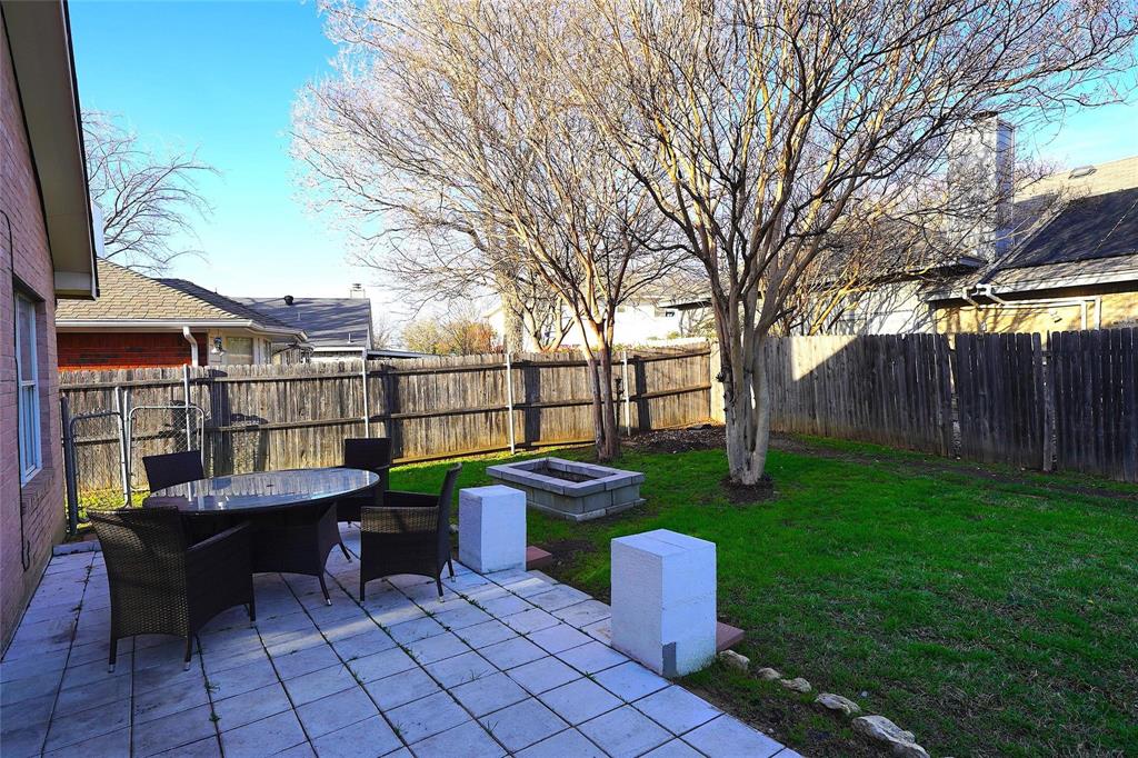 8164 Heritage Pl Drive Fort Worth, TX 76137 - Photo 8 of 8 a view of a chairs and table in the backyard