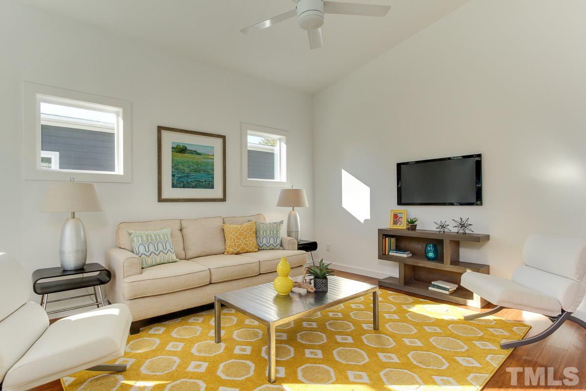 1306 South East Street Raleigh, NC 27601 - Photo 3 of 24 a living room with furniture and a flat screen tv