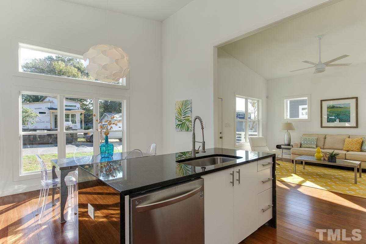 1306 South East Street Raleigh, NC 27601 - Photo 10 of 24 a kitchen with a table chairs and stove
