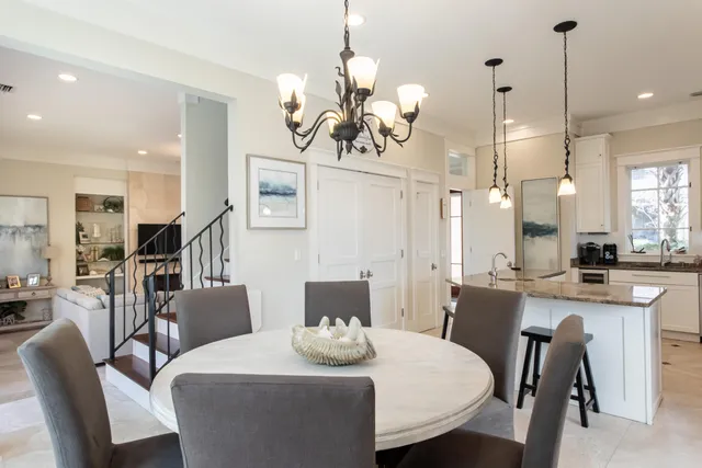 a view of a dining room with furniture wooden floor and chandelier
