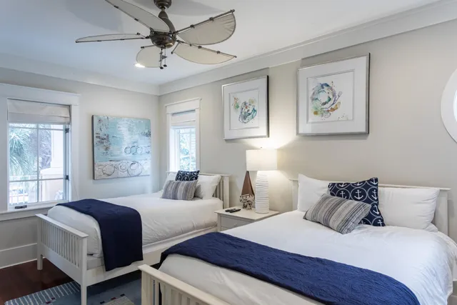 a bedroom with two beds and a large window