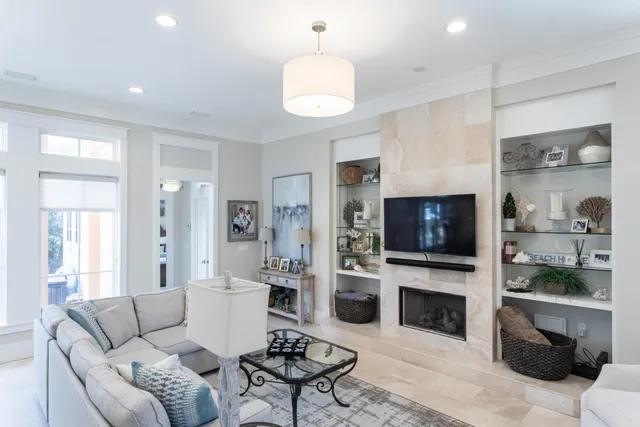 a living room with furniture a fireplace and a flat screen tv