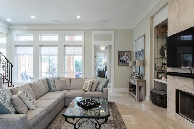 a living room with furniture a flat screen tv and a fireplace