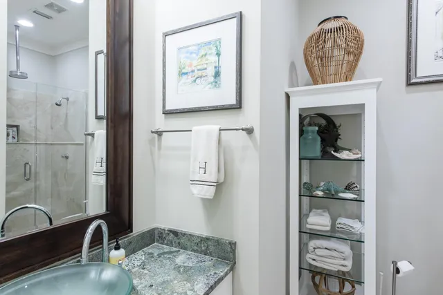 a bathroom with a sink a mirror and a shower